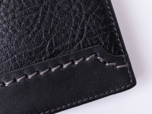 istock lose-up of black grainy and smooth leather with decorative grey stitching 1368682130
