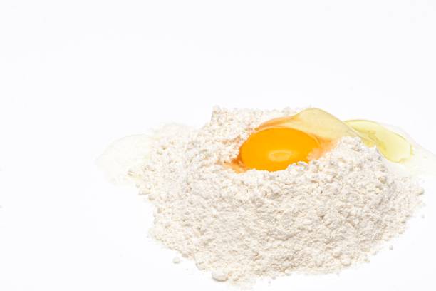 istock Wheat flour with raw egg yolk on top 1368692198
