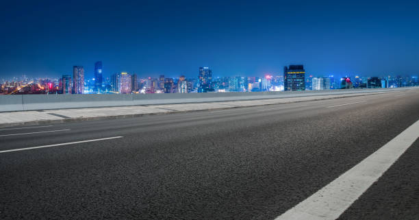 istock Asphalt road and city night scene 1368692973