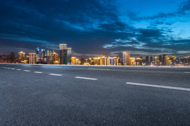 istock Asphalt road and city night scene 1368696208