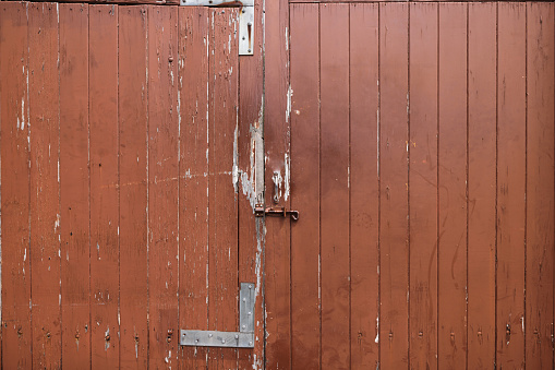 Old cracked and peeling garage door.