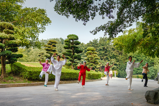 Senior citizens doing Tai chi at the Qing Xiu Park in the morning, Nanning, Guangxi, China