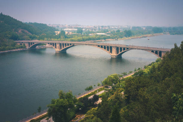 Longmen Bridge over Yi River (Yi He) at The Longmen Grottoes, Luoyang, Henan, China