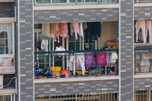 A balcony with laundry and cleaning supplies stock photo