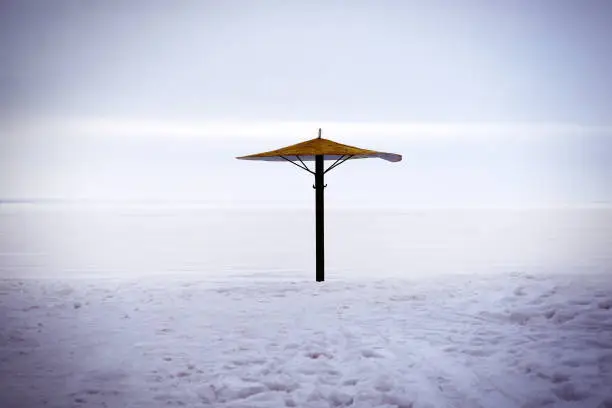 Toned Photo of Umbrella on the Snow at the Winter Beach