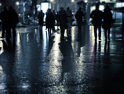 Toned Photo of the Defocused People on the Night Street