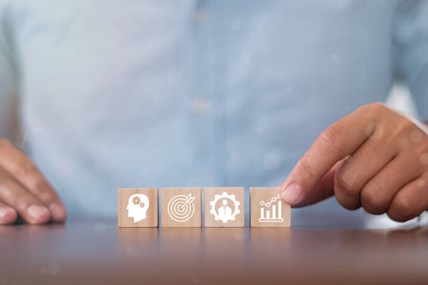 istock Hand puts wooden cubes with knowledge, skills, experience, performance and goals icon on grey background with .copy space. Banner competence, skills and knowledge concept. 1368719969