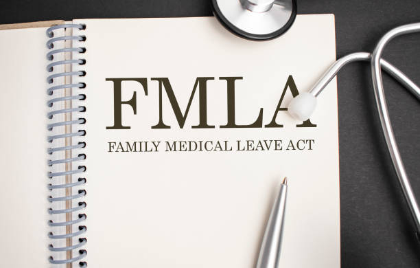 Page with FMLA Family Medical Leave Act on the table with stethoscope, medical concept stock photo