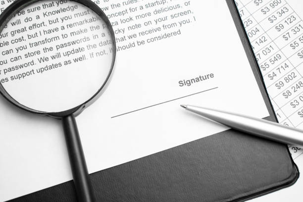 istock Signaure line in contract with pen and magnifying glass 1368729023