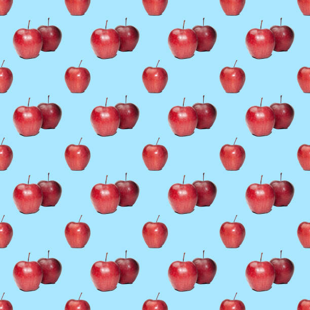 seamless pattern of red apples on a blue background. High quality photo