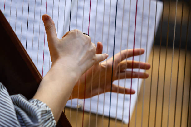 istock Hands of a woman playing the harp 1368731897