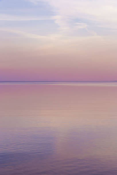 istock Sky background on sunset, colorful clouds. Nature abstract composition with reflections on sea water. Nature environment. 1368732031
