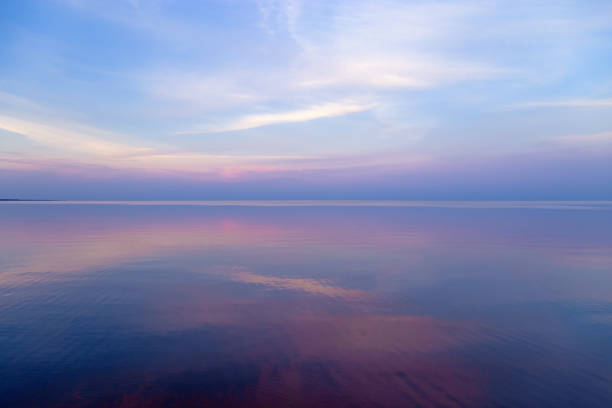 istock Sky background on sunset, colorful clouds. Nature abstract composition with reflections on sea water. Nature environment. 1368732033