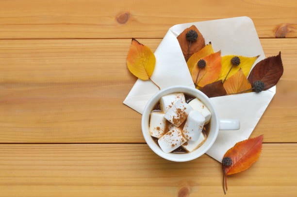 istock A Cup of Marshmallow Coffee & Envelope Filled with Autumn Colored Leaves 1368732074
