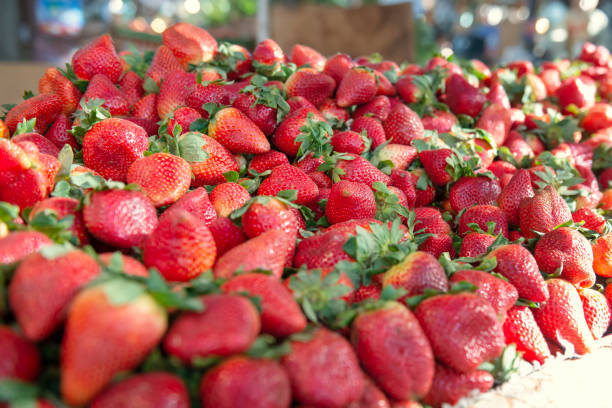 Big pile of fresh juicy strawberries in a market
