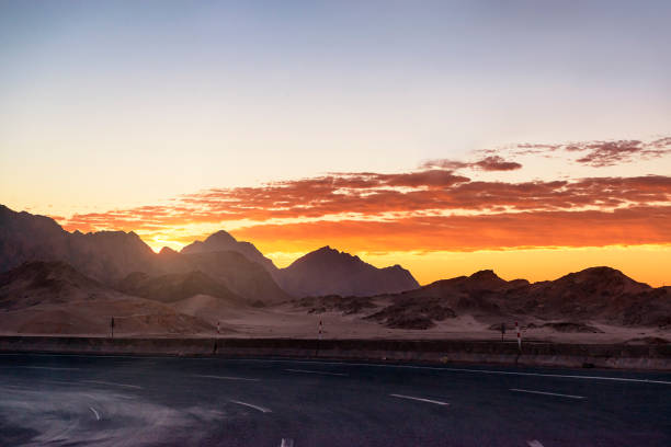 Sunrise desert road stock photo