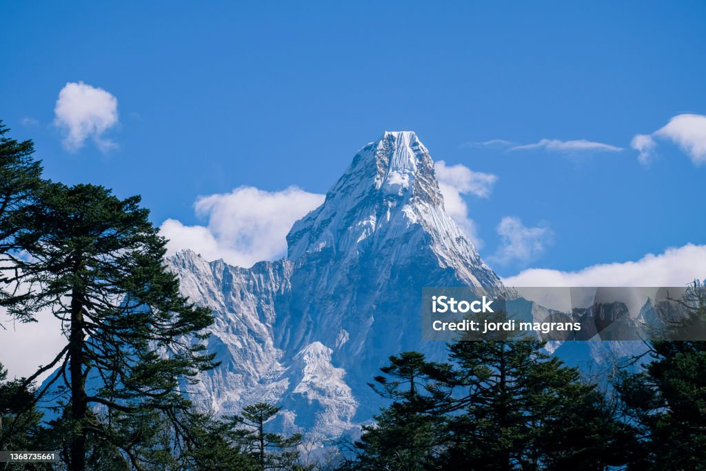 views of Ama Dablam on the way to Everest Base Camp views of Ama Dablam on the way to Everest Base Camp with trees in the foreground Ama Dablam Stock Photo