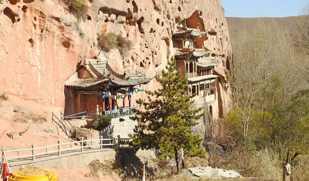 About 70 km from Zhangye, flanked by the Qilian Mountains, are the temples of Mati Si. These Buddhist temples are dug into the mountainside, forming a series of temple-caves interconnected with each other by narrow passageways with hanging balconies.