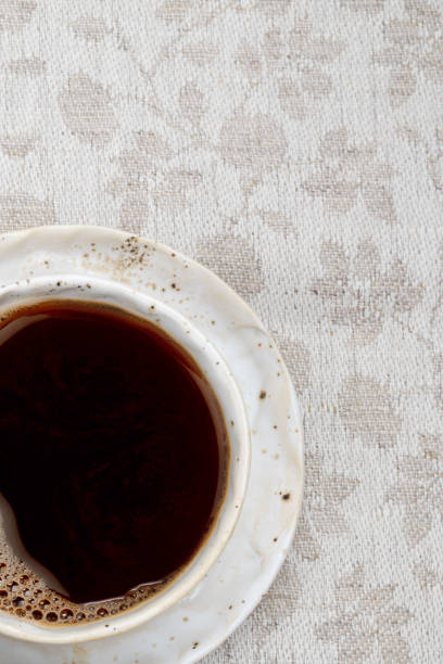 istock white coffee Cup on wooden background with grey linen tablecloth in jacquard weave, space for text 1368745948