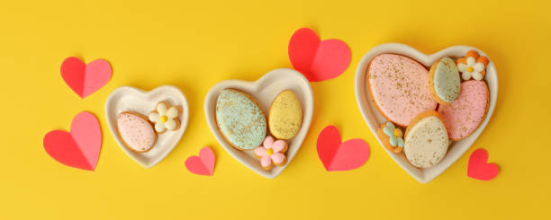 istock Sweets, pastry, gingerbread cookies for Easter table. Easter eggs heart shaped decor  on yellow background top view copy space, spring seasonal holiday banner for your site, flyer, coupon 1368746885