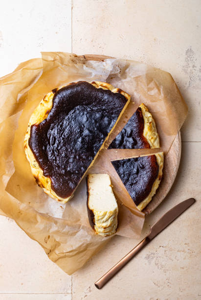 istock San Sebastian Basque Burnt Cheesecake.  Basque burnt cheesecake on baking paper. Top view 1368747109