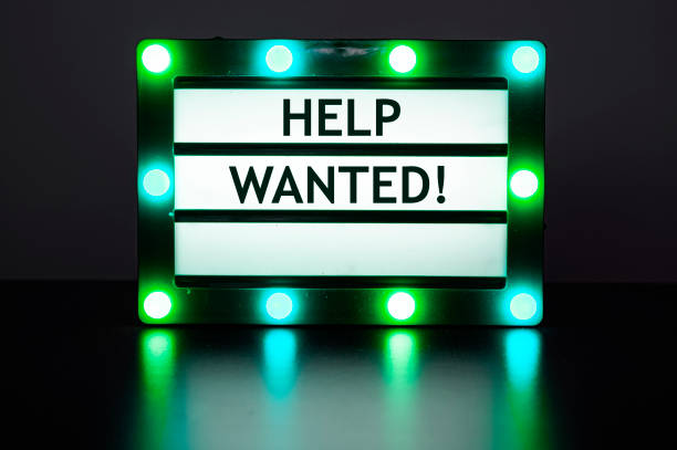 istock Lightbox with green lights in dark room with words - help wanted! 1368751919