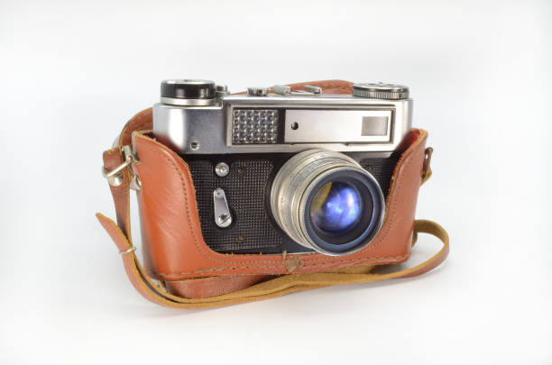 istock Old film camera in a leather case on a white background. 1368757792