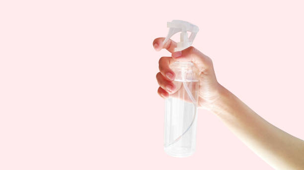 istock Close-up view hand holding a spray bottle. Homemade disinfectant. Background with empty space 1368759886
