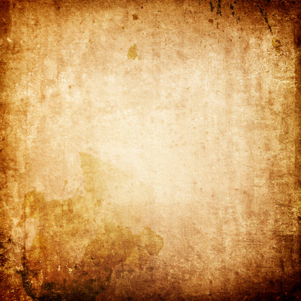 Old grunge background of worn yellowed stained paper The texture of old brown paper with vintage spots and splashes and a faded center yellowed edges stock pictures, royalty-free photos & images