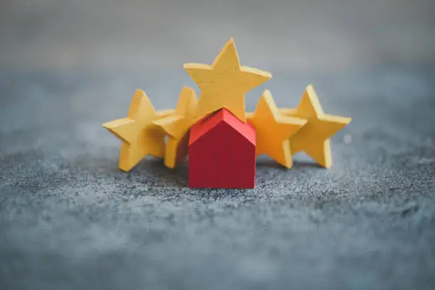Photo of Wood red home with yellow star rating feedback and press level excellent five rank for giving best score.