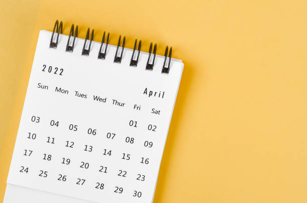 istock April 2022 desk calendar on light yellow background. 1368761668