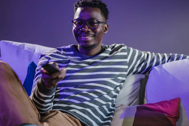 Young man at home watching TV