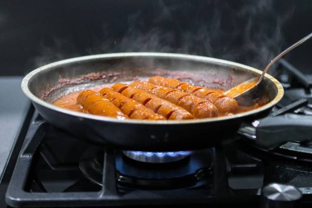 istock Cooking sausages with sauce in the kitchen. 1368763831