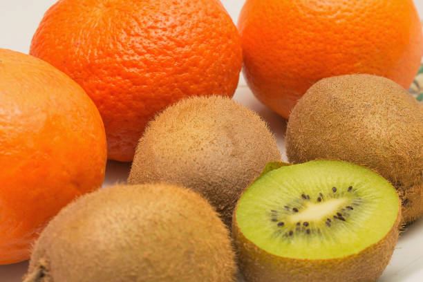 Fresh happy fruit face with slices of kiwi and tangerine