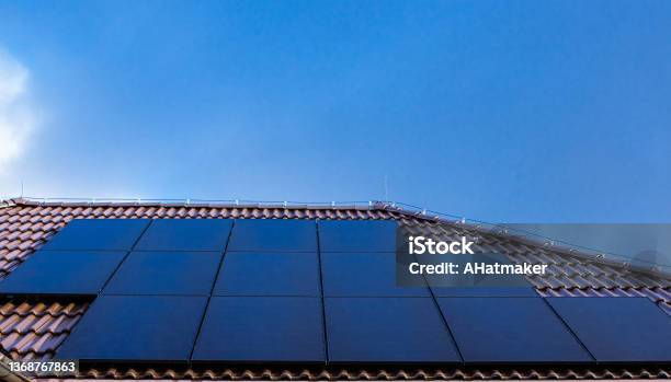 Modern Full Black Solar Panels On The Roof Of A House Stock Photo - Download Image Now
