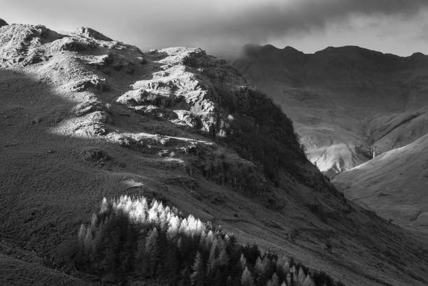 istock Black and white Autumn landscape image looking from Pike O'Blisco towards Langdale Pikes and Range with beautiful sungiht on mountains and valley 1368772448