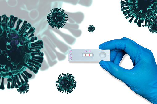 Hand holding Rapid Antigen Test kit(ATK) with Positive result during swab COVID-19 testing.