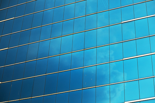 Blue fensterfront and facade of modern office building in Bangkok