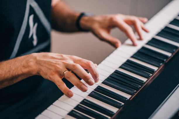 istock Man's hands on the keys of a piano 1368778920