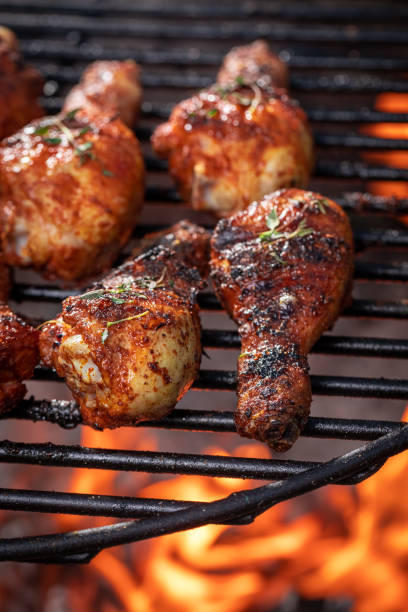 istock Hot roasted chicken leg on grill grate with fire. 1368779077