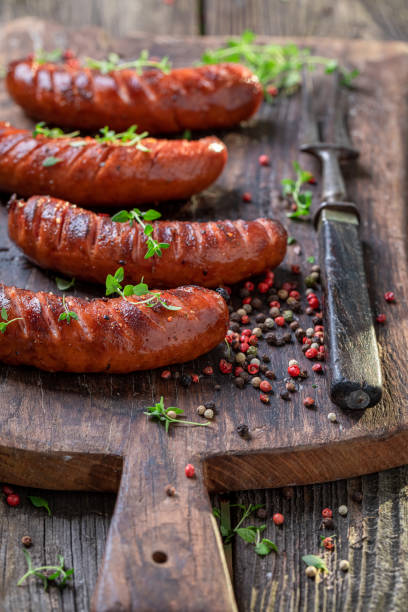istock Hot roasted sausages with herbs and spices. 1368779379