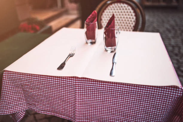 istock Cafe table covered with a tablecloth and served with appliances 1368780358