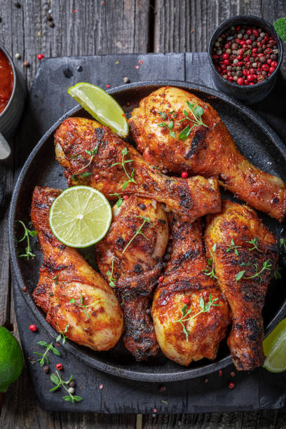 istock Hot roasted chicken leg with herbs and spices. 1368780544