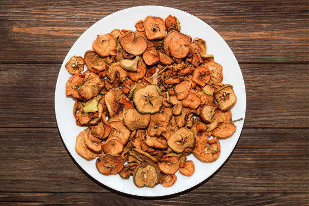istock Dried apple fruits on a plate on a wooden table 1368781529