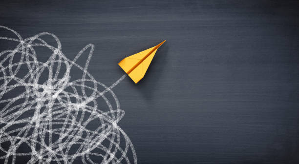 istock Yellow paper airplane on chalkboard 1368781681