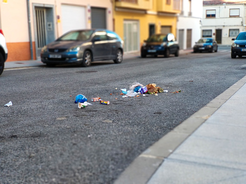 Ibi, Spain - November 2nd 2020. Common problem in a town without dumpsters. Rubbish thrown in the street without bag.