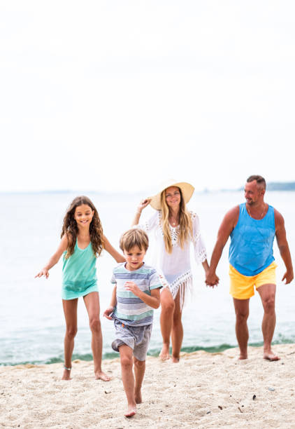 istock children running on the beach 1368785316