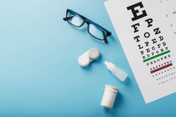 istock Ophthalmic Accessories Glasses and lenses with an Eye Test Chart for vision correction on a blue background 1368785464