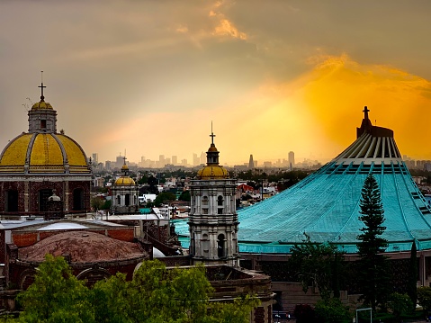 The Basilica of Guadalupe houses the cloak with the image of Guadalupe as it appeared to Saint Juan Diego - this view is from the original hill of Tepeyac overlooking the Mexico City skyline