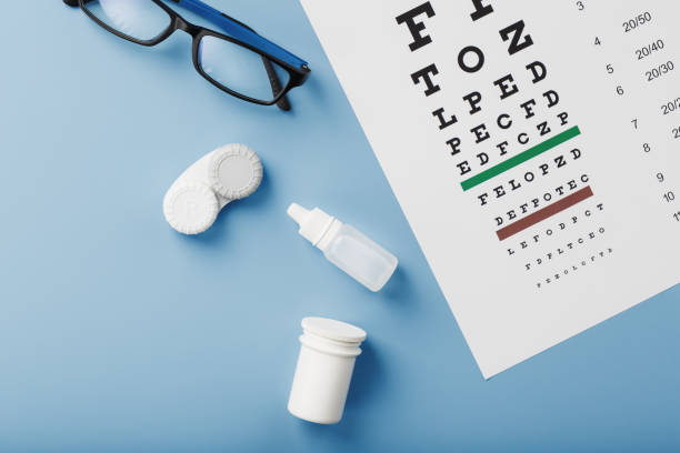 istock Ophthalmic Accessories Glasses and lenses with an Eye Test Chart for vision correction on a blue background 1368785682
